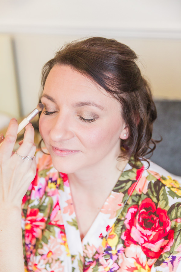 bride in her dressing gown having her makeup done on the morning of her wedding fine art wedding photography bank house worcester worcestershire image by hayley morris photography