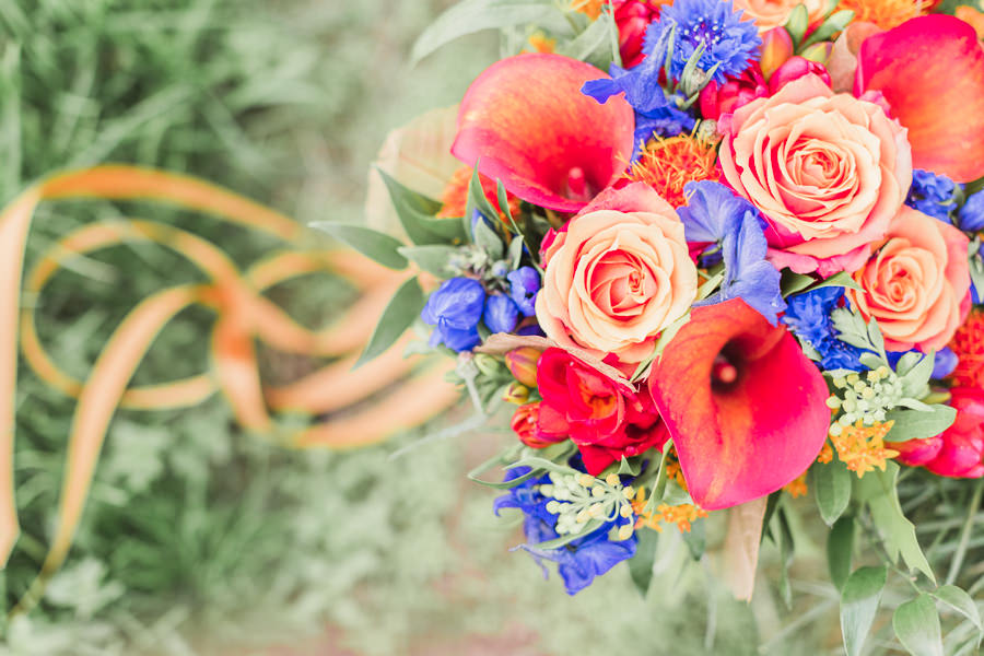 wedding photography herefordshire wedding flowers herefordshire flower studio - vibrant wedding flowers and bouquet with ribbons flowing from the bouquet - image by hayley morris photography