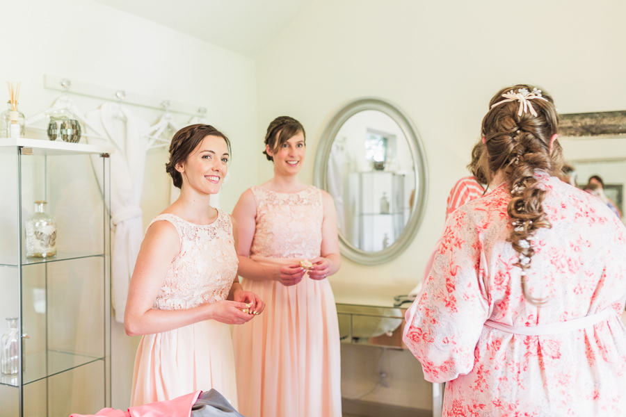 LEMORE MANOR FINE ART WEDDING PHOTOGRAPHY HEREFORD HEREFORDSHIRE WALES SOUTH WALES ROSS ON WYE LEOMINSTER image by hayley morris photography of a bride passing gifts to her bridesmaids on the morning on her wedding
