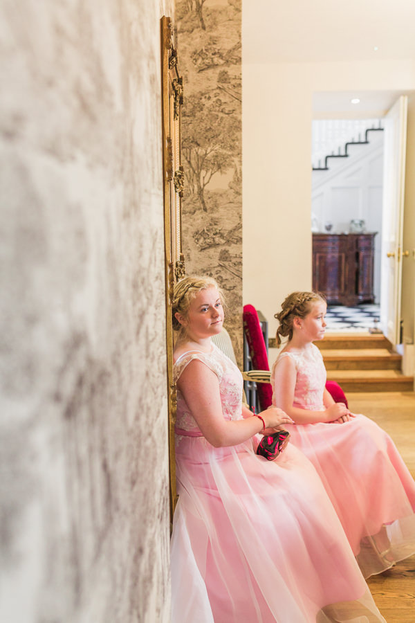 stanbrook abbey malvern worcester worcestershire fine art wedding photography documentary style light and airy romantic images photos - image shows bridesmaids waiting patiently for the preparations to be complete on the morning of a wedding - image by hayley morris photography at standbtrook abbey