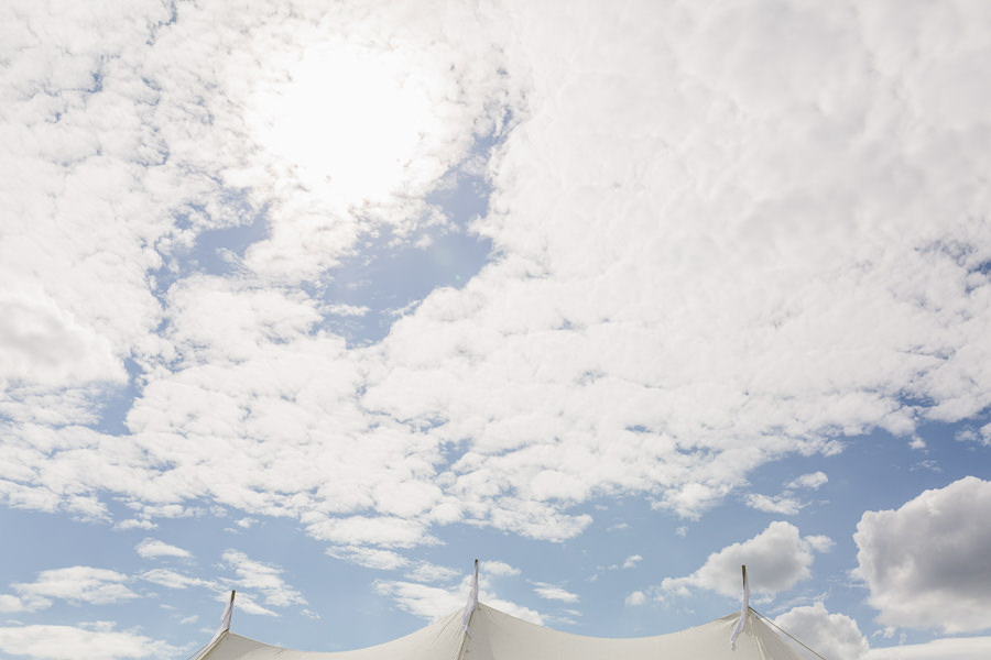 wedding photography cotswolds fine art wedding photographer Gloucestershire - wedding marquee peaks of the tent and clouds in the sky