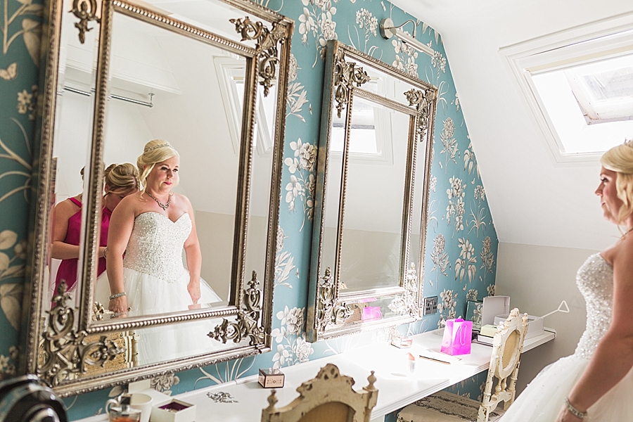 stanbrook abbey wedding photographer fine art wedding photography malvern worcester worcestershire ledbury - image shows a bride looking at herself in the mirror just as she's getting dressed for her wedding - image by hayley morris photography