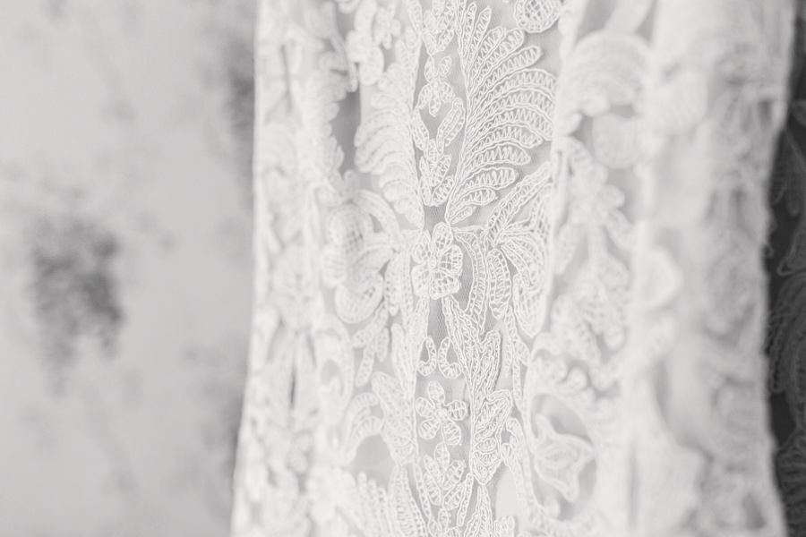 fine art wedding photography kidderminster bride's lace detail of her dress hanging at kateshill house - image by hayley morris Photography