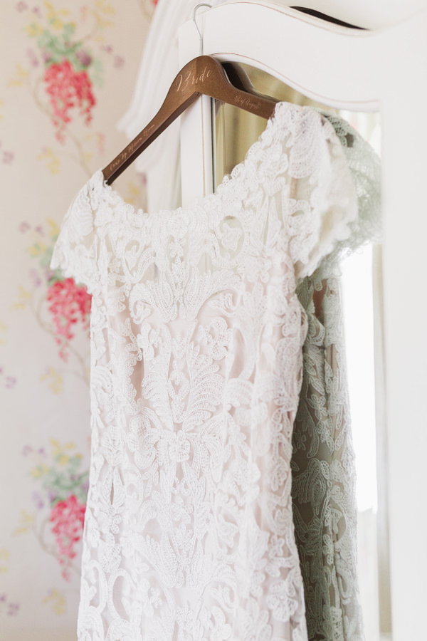 fine art wedding photography worcestershire west midlands bride's lace wedding dress hanging at kateshill house by hayley morris photography