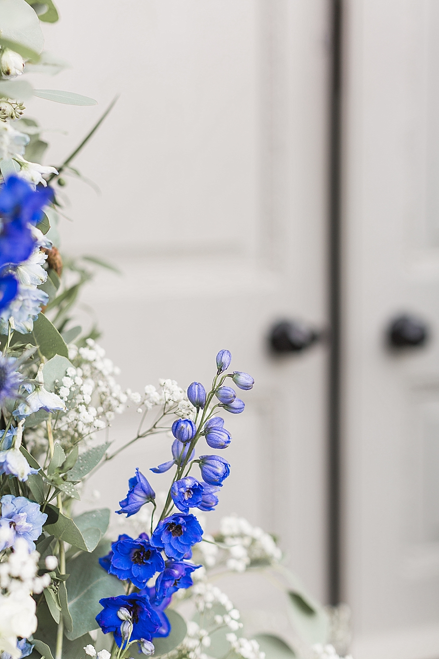 View of flowers by herefordshire flower studio and the door at letton court wedding venue herefordshire near wales by hayley morris photography