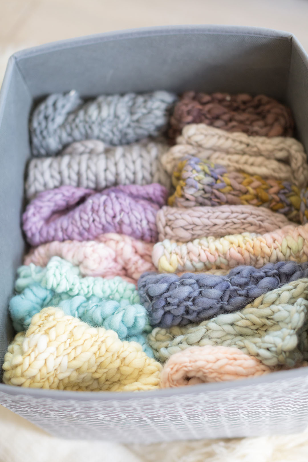Knitted colourful layers in a box ready and prepped for a newborn photography session in my studio