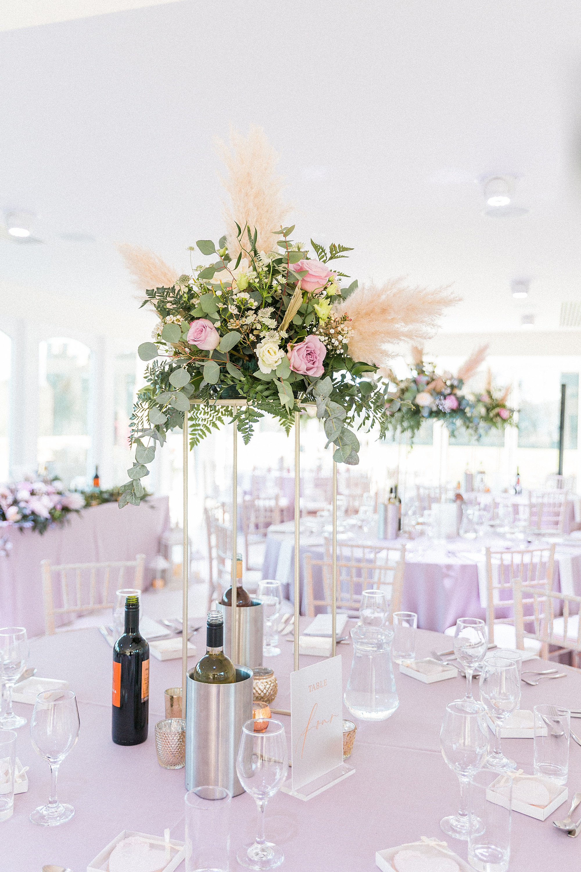 photo of the orangery at arley house decorated and set up ready for a wedding reception with pastel shades, beautiful floral table decor and gold too 