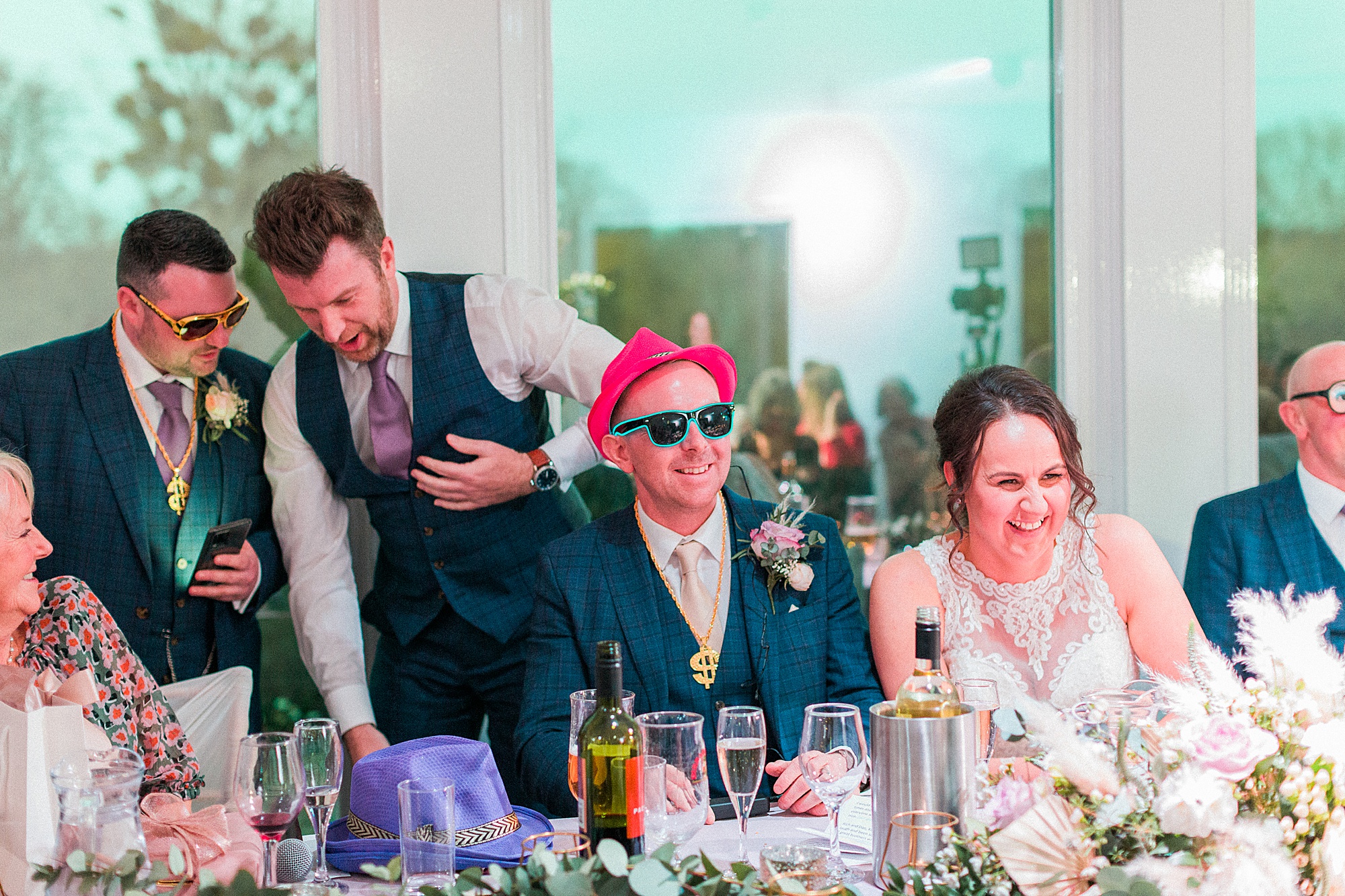photo of gents including the groom and his two best men at a wedding wearing light up props and accessories during the speeches 