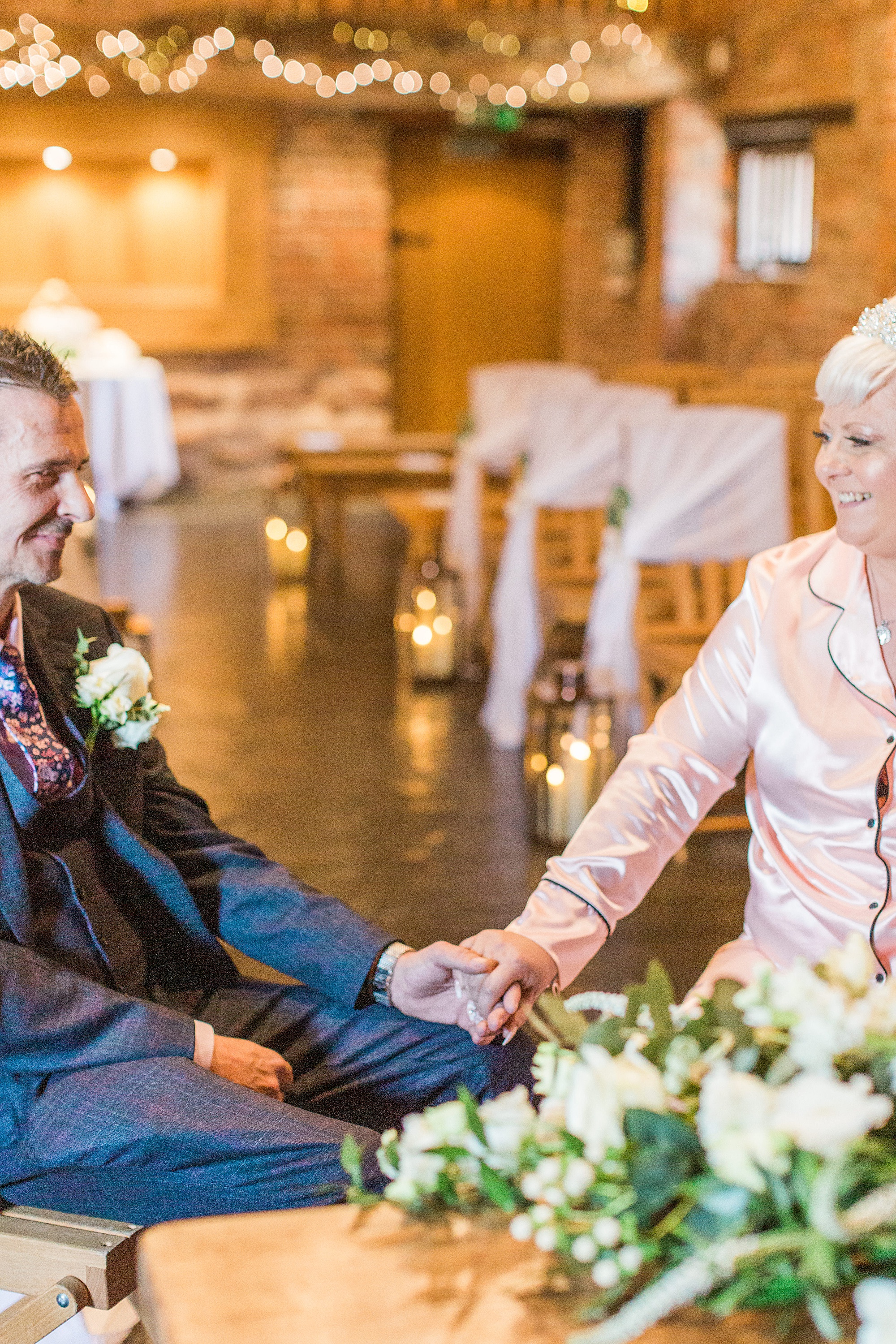 photo of a couple getting married at curradine barns. The bride is dressed in satin pyjamas and the groom is in a suit, this was the legal ceremony before their humanist ceremony 