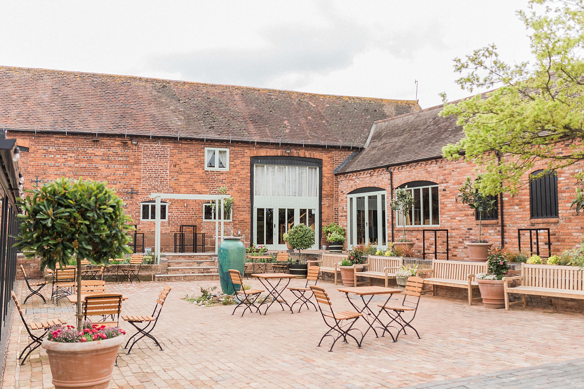 Exterior view of curradine barns shrawley worcestershire - image shows the courtyard and their new extensive with the barns in the background 
