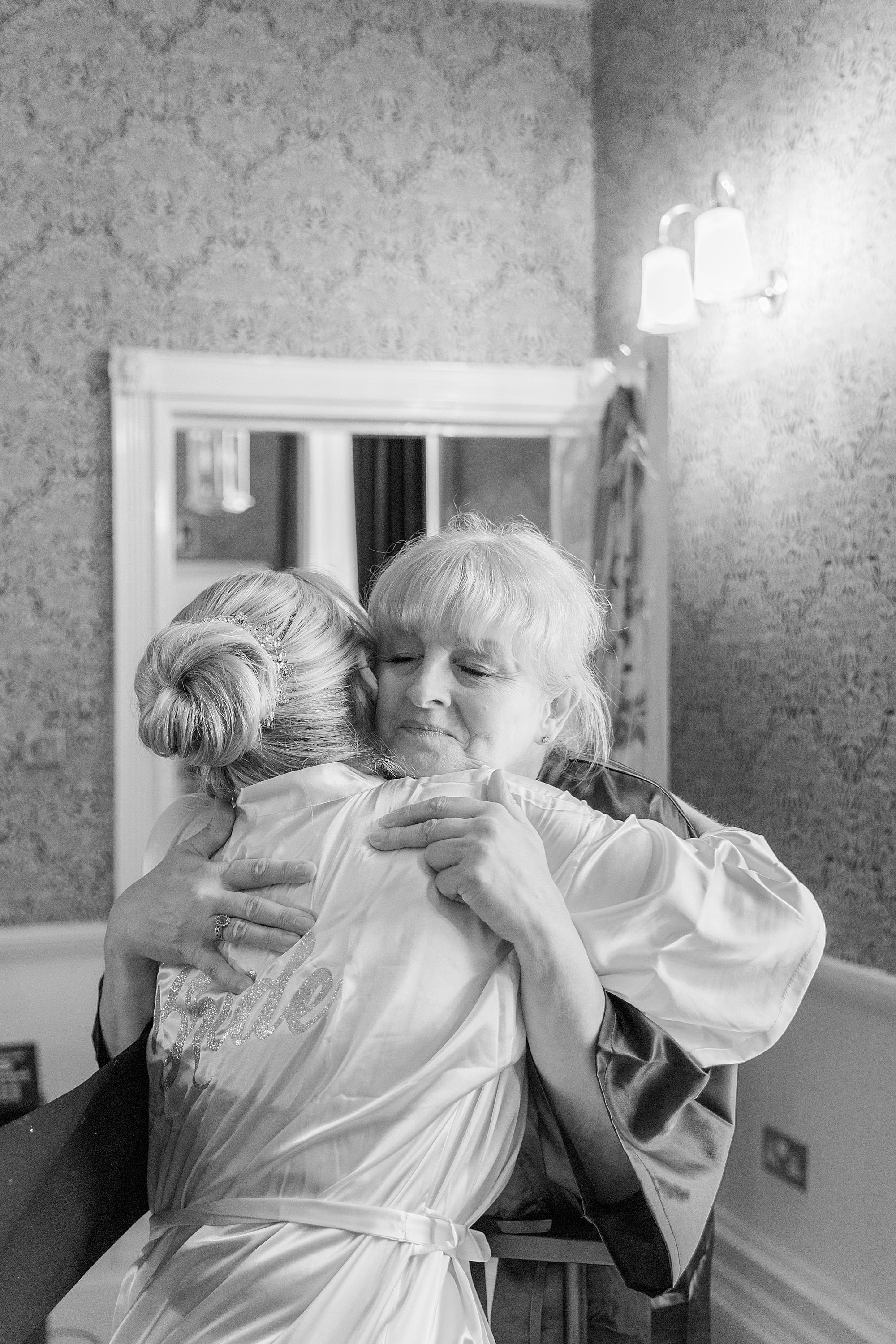photo of a bride and her mum hugging on the morning of the bride's wedding