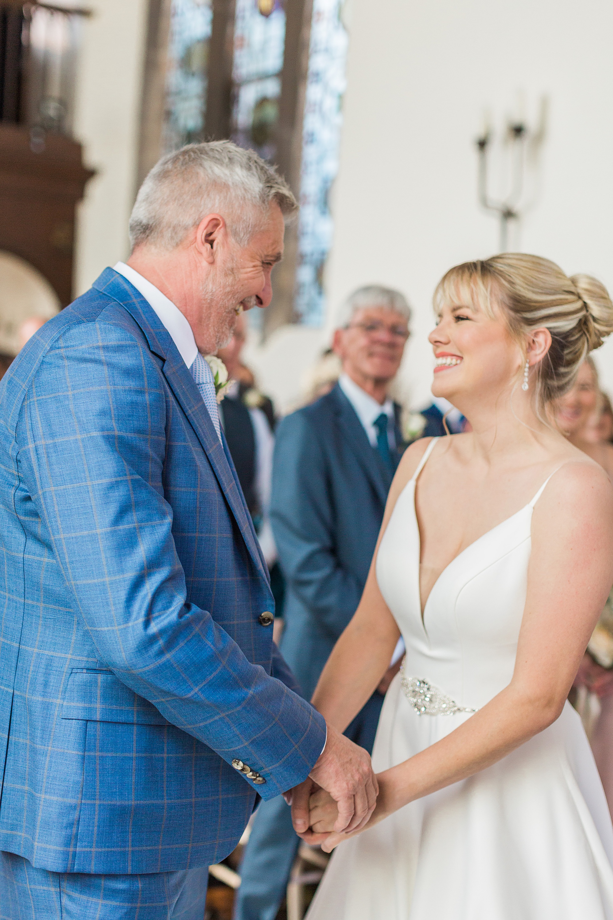 bride and groom facing towards each other smiling during their wedding ceremony at grafton manor