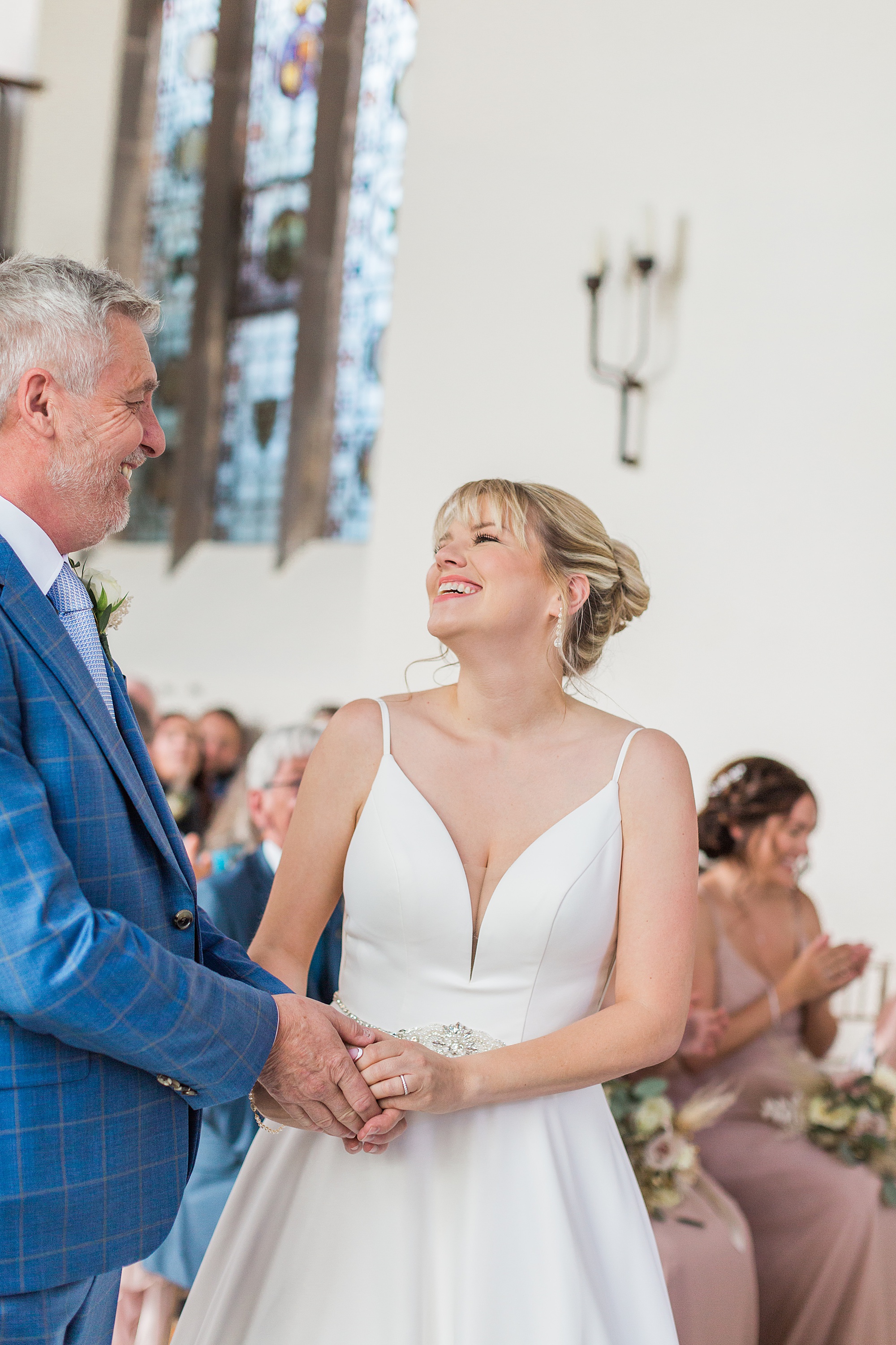 photo of a bride groom laughing during their ceremony at groton manor near bromsgrove 