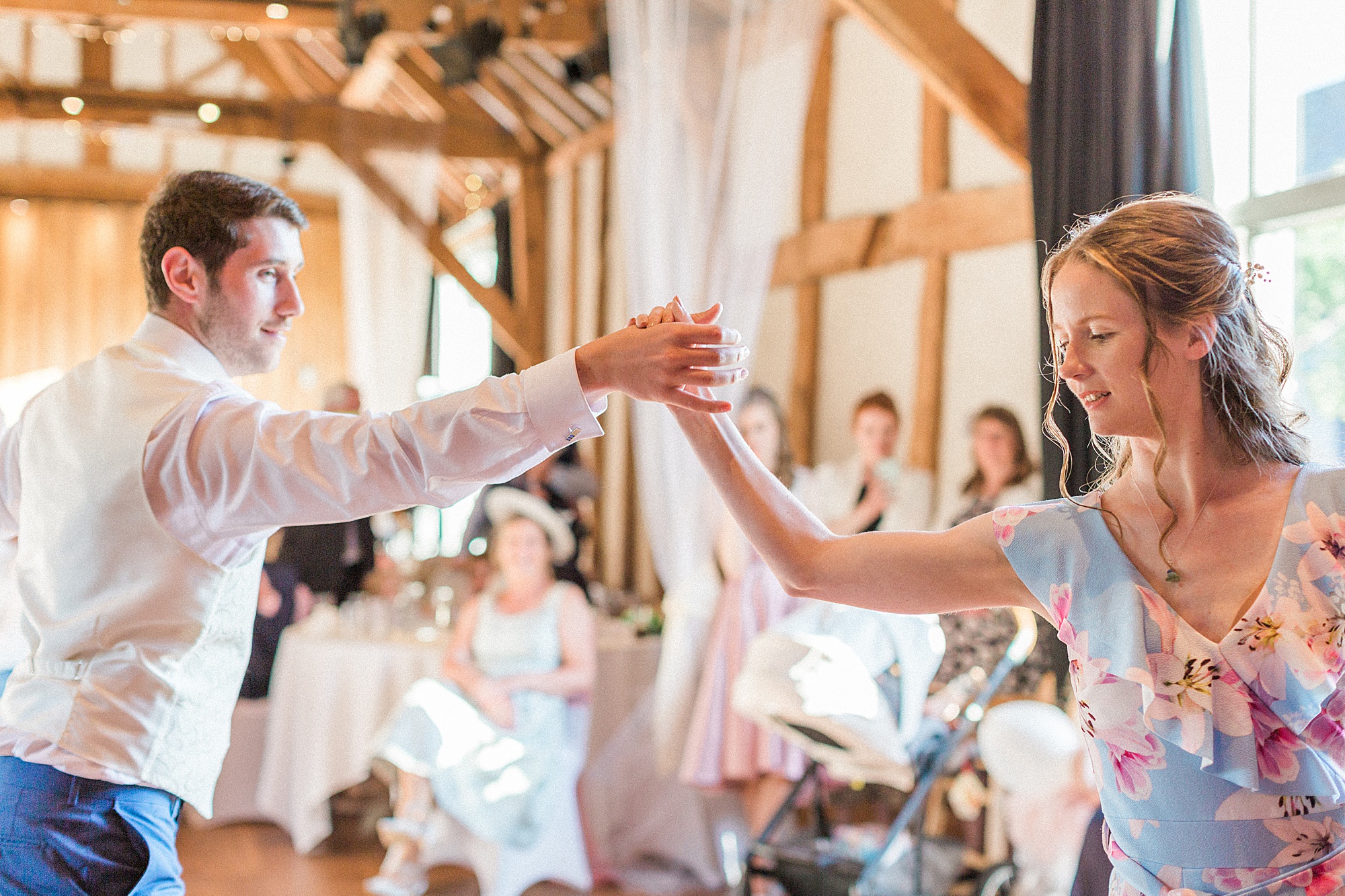 Photo of a bride and groom dancing their choreographed first dance at their wedding in a barn at hellens manor in herefordshire