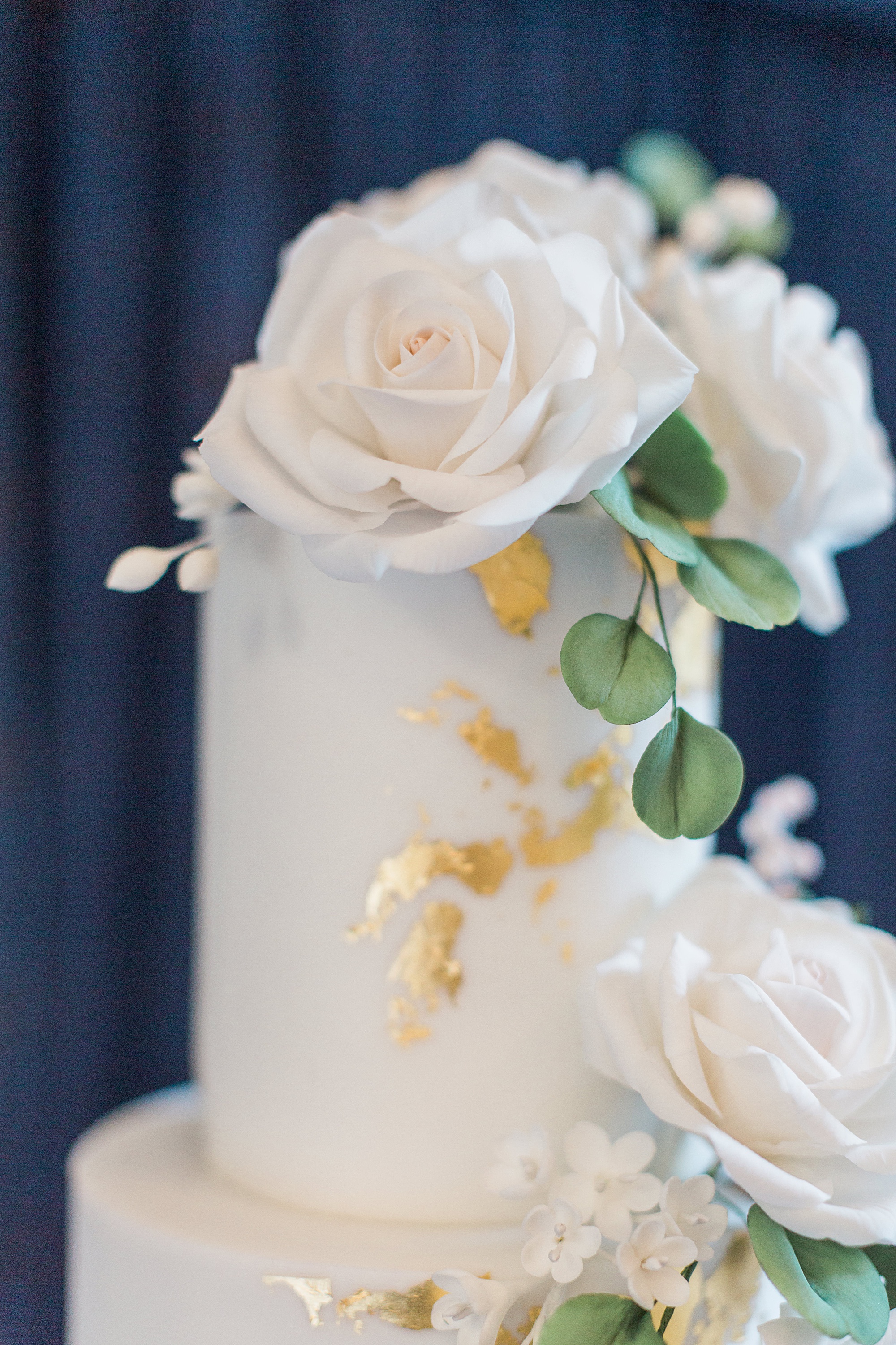 photo shows the detail of a wedding cake including the intricate icing and flowers made by the cake maker. The cake is by karen McGowan and at the abbey hotel malvern 