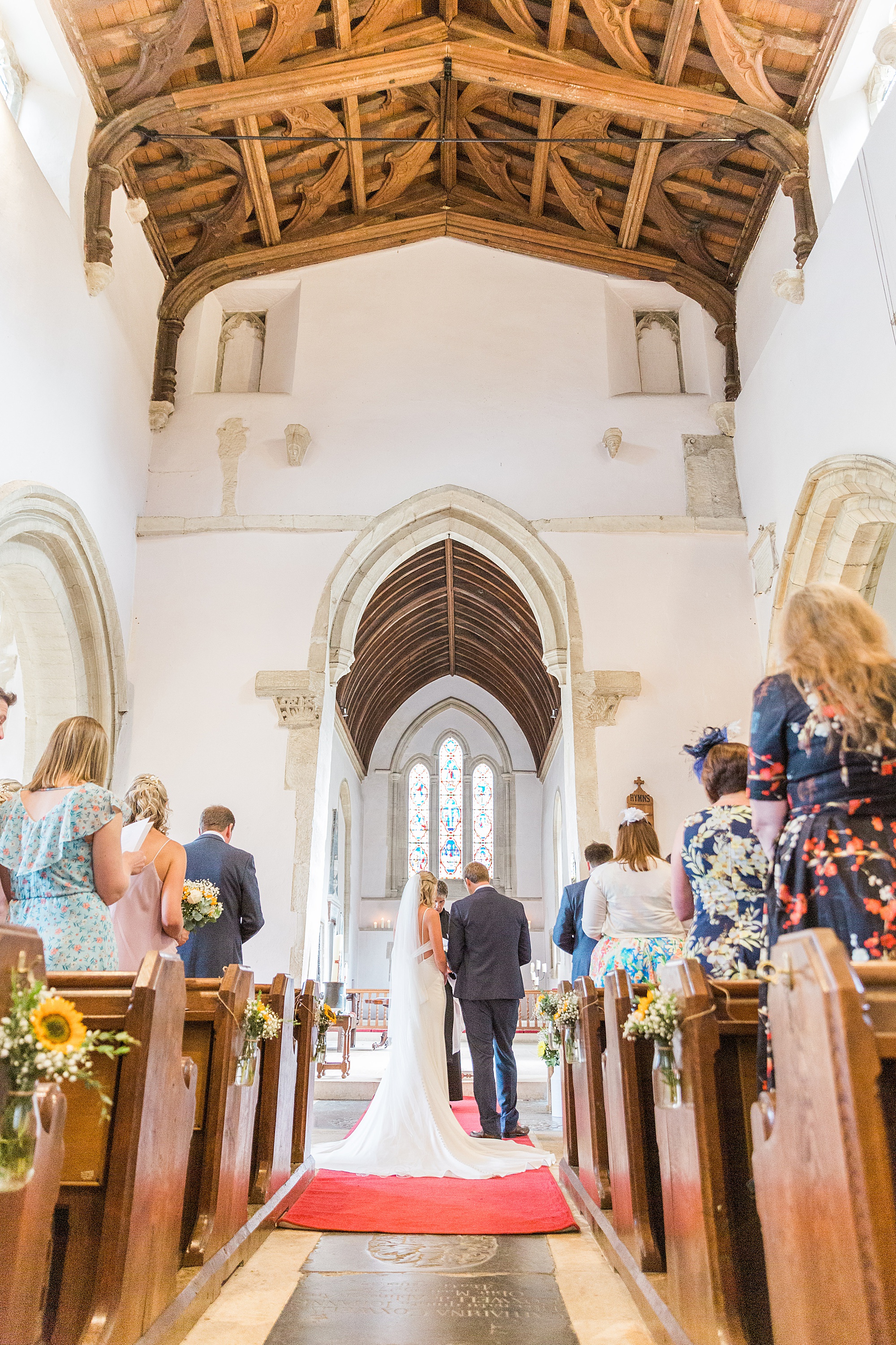 photo of a couple getting married at the church at bibury in the cotswolds 
