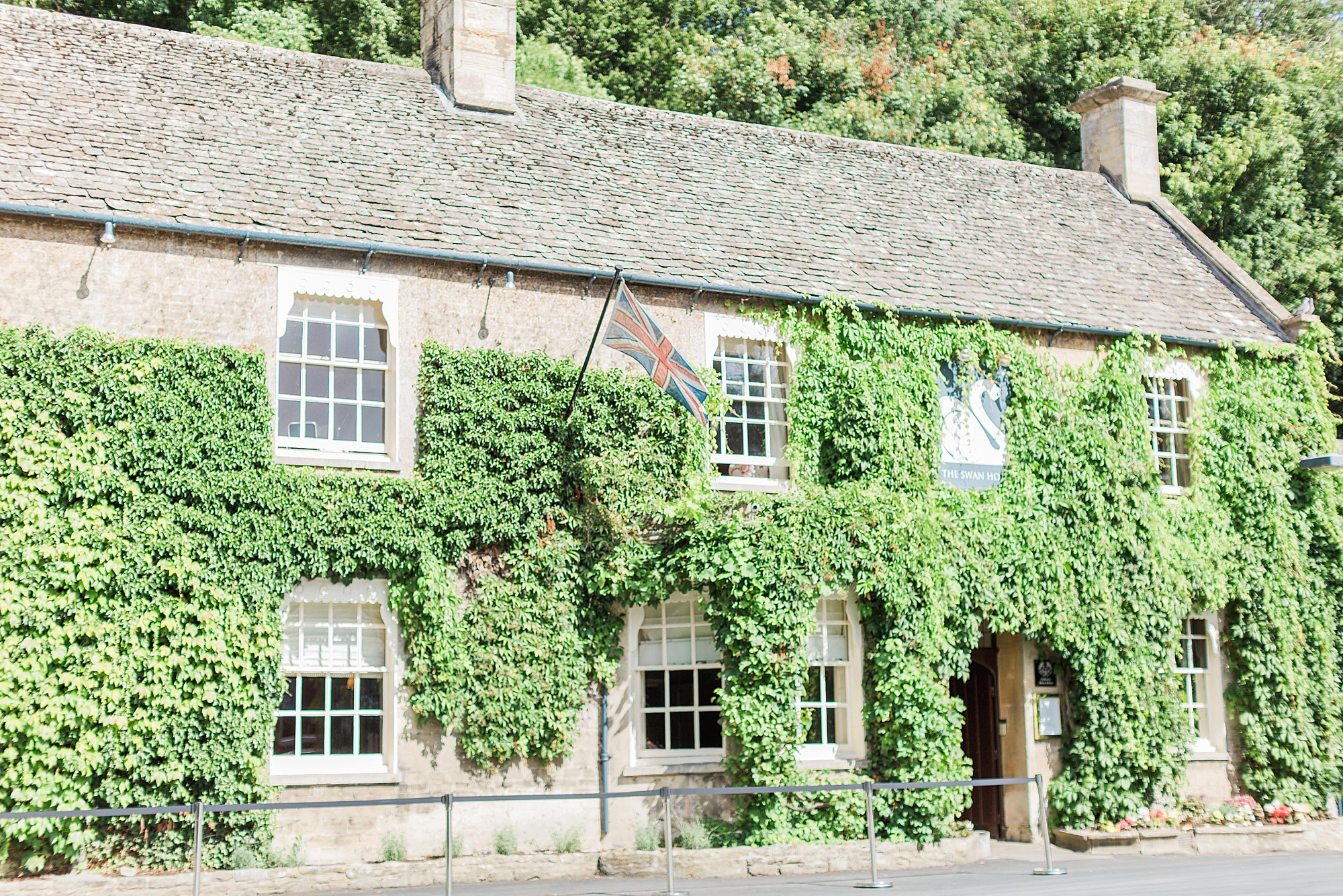 photo showing the exterior of the swan at bibury on the day of a wedding in the cotswolds in summer 2022