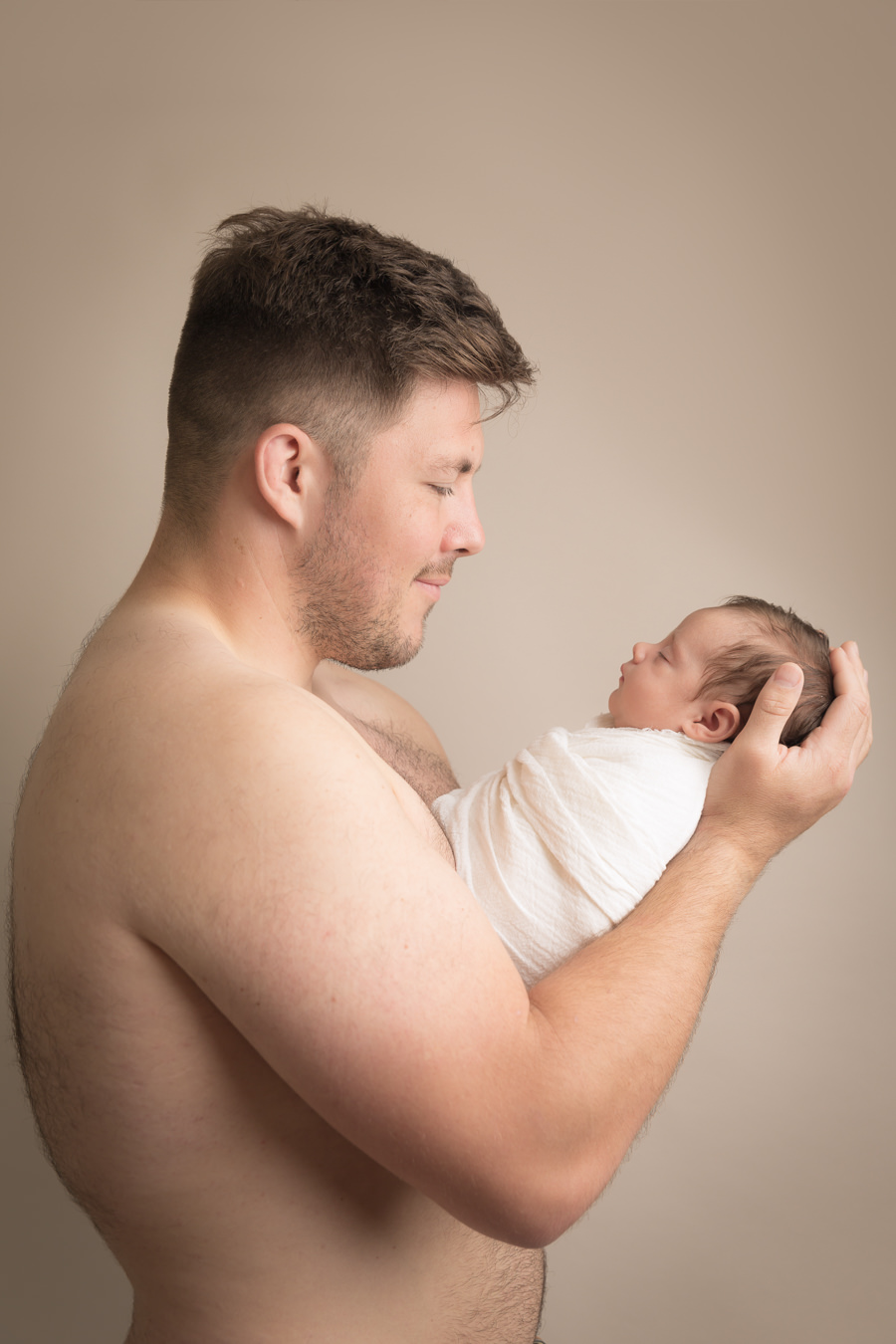Hayley Morris Photography newborn photographer malvern Worcestershire dad skin to skin photo holding baby