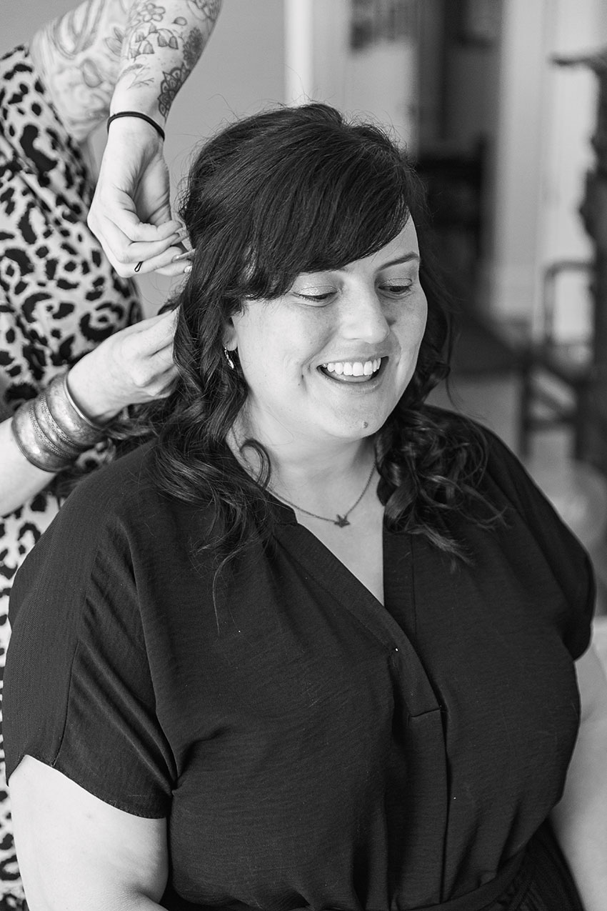 Bride having her hair done by a hairdresser getting ready for her wedding
