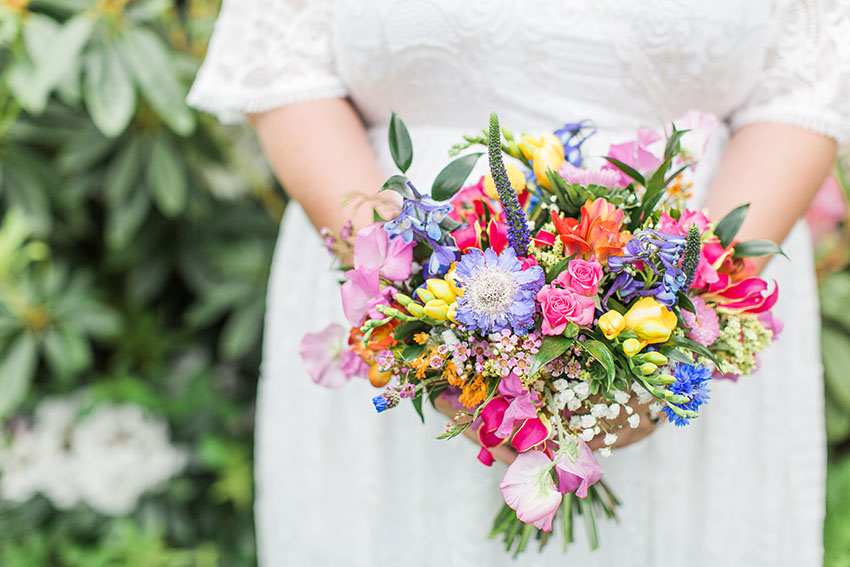 close up photo of the bride holding her colourful and vibrant bouquet 