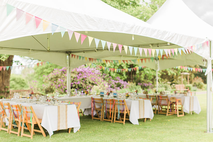 Wide photo of the sideless marquee at an outdoor wedding reception on the lawn at homme house 